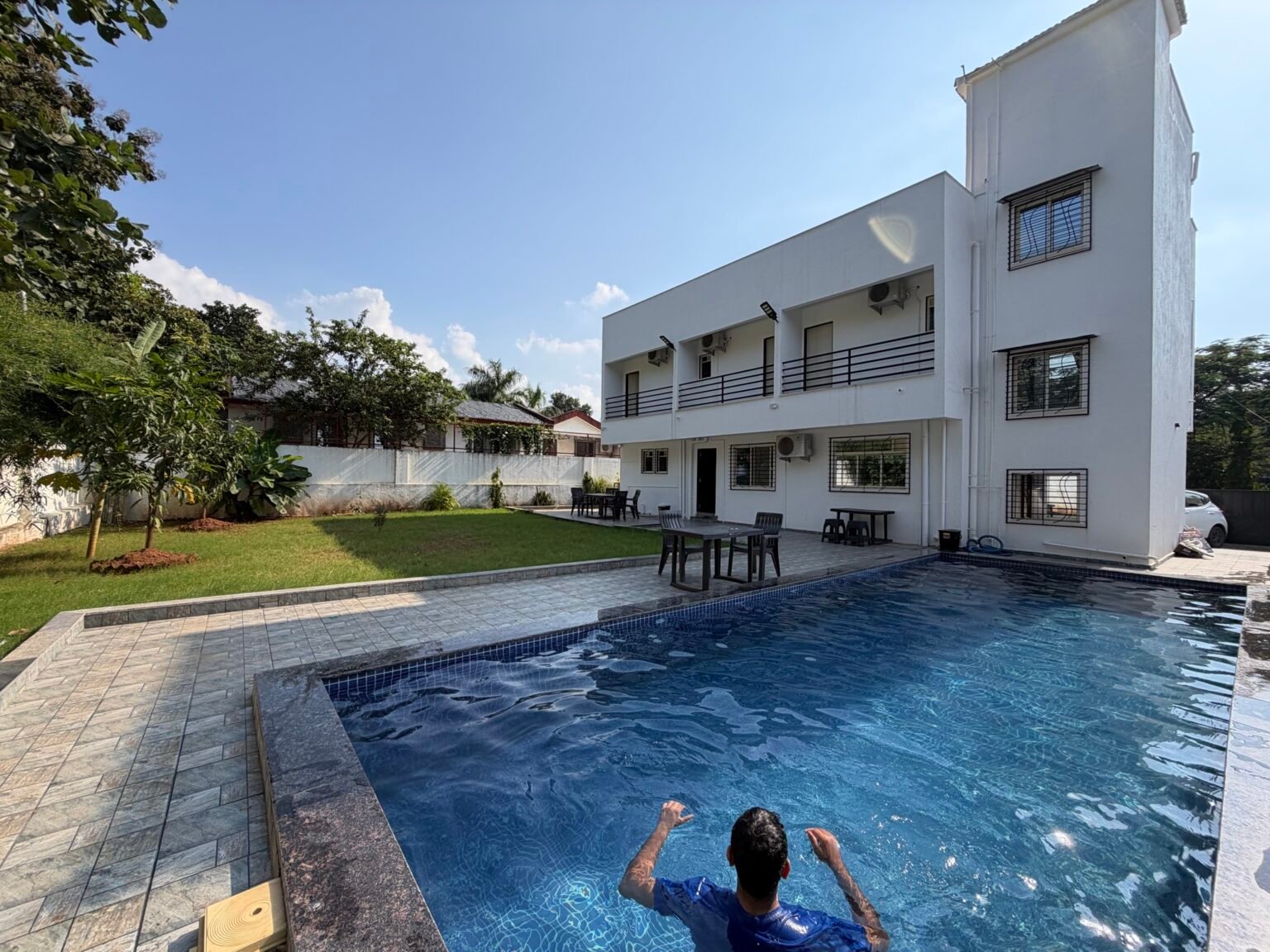 Nandan Villa, a white two-storey villa with a private pool and lawn in Karjat